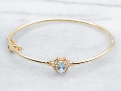 Made from stunning yellow gold, this bracelet features a beautiful oval-cut aquamarine gemstone and a hinged design for easy wear. Perfect for adding a touch of elegance to any outfit.Metal: 14K Yellow Gold Gem: Aquamarine .60 CaratsGem Measurements: 4.8 x 6.9 mm, Oval Inside Circumference: 6 1/2 Inches Yellow Gold Bangle, Aquamarine Jewelry, Bracelet Gemstone, Gold Bangle Bracelet, Gold Bangle, Aquamarine Gemstone, Hinged Bangle, Gold Bangles, Gemstone Bracelet