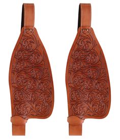 two brown leather saddles with floral designs on the sides and one in the middle