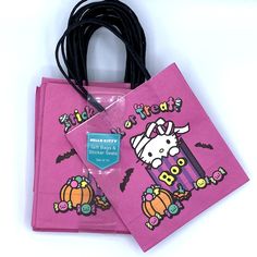 two pink bags with cartoon characters on them and a black cord attached to the bag