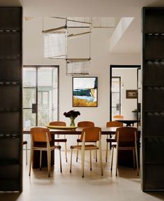 the dining room table is surrounded by wooden chairs