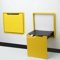 a yellow and black box on the side of a wall next to an open file cabinet