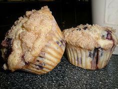 two blueberry muffins sitting on top of a counter