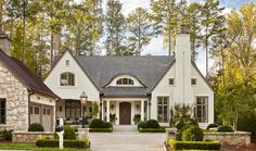 a white house surrounded by trees and bushes