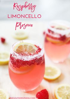 raspberry limocelllo piscoa cocktail with lemons on the side