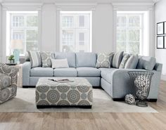 a living room filled with lots of furniture and decor on top of a hard wood floor