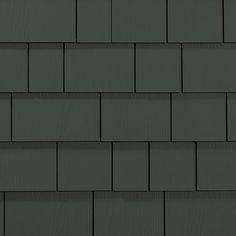 a close up view of a dark gray roof shingles with white lines on it