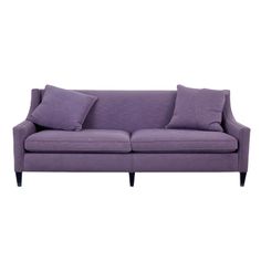 a purple couch with two pillows on it's back and one arm facing the camera