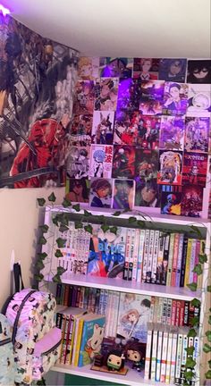 a book shelf filled with lots of books next to a wall covered in anime pictures