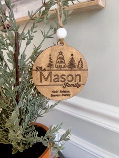 a wooden ornament hanging from a tree with the name mason family on it