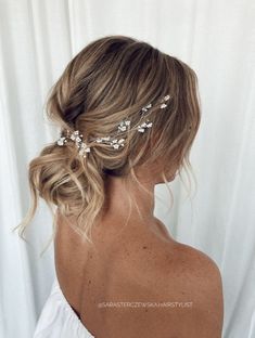 a woman with blonde hair wearing a white dress and a flowered headpiece in her hair