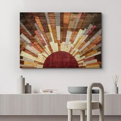 an abstract painting on the wall above a table