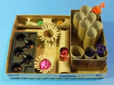 an open cardboard box filled with craft supplies