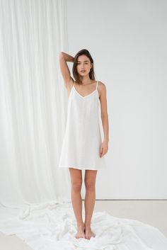 "Basic TILDA cami dress in milky white. - length is ± 92 cm (36.2\") (depends on size) - without pockets - relaxed fit DETAILS: - 100 % European, pre-washed medium weight linen (205 g/m²) - the model is 180 cm (5′11″) high, wearing size S. - model measurements: bust 84 cm (33\") / waist 61 cm (24\") / hips 92 cm (36\") - color in the picture - milky white (you can choose other color on the right) MADE TO ORDER: All pieces are made to order, it will take up to 10 work days to complete your order. White V-neck Slip Dress With Delicate Straps, White V-neck Slip Dress With Adjustable Straps, White Suspender Dress For Summer Wedding, White Summer Wedding Suspender Dress, White V-neck Suspender Dress With Adjustable Straps, Summer Wedding Night V-neck Nightgown, Elegant White Sundress With Adjustable Straps, White Slip Dress With Delicate Straps For Spring, White Sundress With Spaghetti Delicate Straps