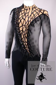 a mannequin wearing a black and silver outfit with sequins on the back