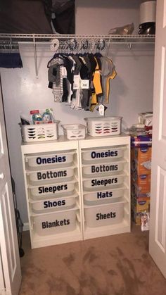 an organized closet with baskets and clothes hanging on the wall, labeled onesils bottoms sleepers hats blankets