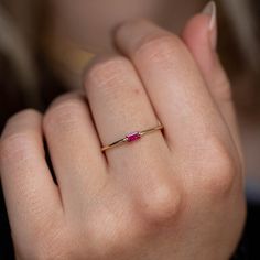 A July birthstone ring with a natural baguette ruby in 14K solid gold. A minimalist ring for women, ideal to be stackable with more dainty rings. A great Christmas gift for her. 100% handcrafted with love! * Material: 14K solid white gold, 14K yellow gold * Gemstone: Ruby, natural gemstone * Ruby's Weight: 0.12 ct * Ruby's Dimensions 4 mm x 2 mm HOW TO ORDER - CUSTOM ORDERS * Choose from the drop-down menus the available options (Ring size, Metal) and leave us a note for any special requirements. * For special orders (if you wish the ring to match an existing engagement ring) forward us pictures of the ring on a ruler from the front, side and top to mark the measurements, so we can adjust the design to fit properly to your engagement ring. PRODUCTION TIME - SHIPPING POLICIES * Please keep Minimalist 14k Gold Red Ruby Ring, Minimalist Ruby Ring For Anniversary, Minimalist Gold Ruby Ring, Minimalist Yellow Gold Ruby Birthstone Ring, Simple Gold Rings For Women, Minimalist Yellow Gold Ring With Ruby, 14k Gold Minimalist Ruby Birthstone Ring, Minimalist 14k Gold Ruby Birthstone Ring, Minimalist Baguette Cut Emerald Ring