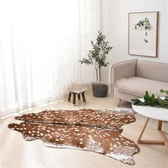 two deer skin rugs in the middle of a living room with white walls and flooring