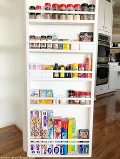 a white pantry shelving unit filled with lots of food