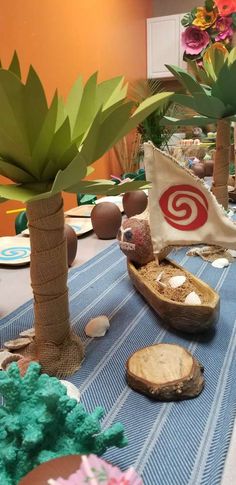 a table topped with palm trees and seashells