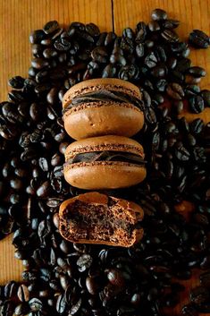 chocolate donuts and coffee beans on a wooden table