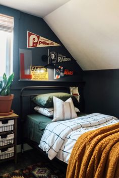 a bedroom with black walls, white and yellow bedding, and a green bedspread