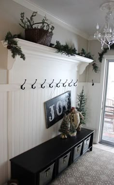 a mantle with christmas decorations on it in a living room