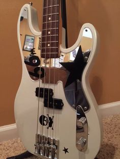 an electric bass guitar sitting on the floor