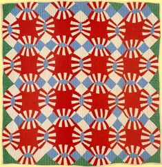 a red, white and blue quilt with circles on it