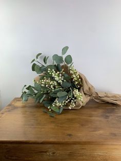 a bouquet of flowers sitting on top of a wooden table