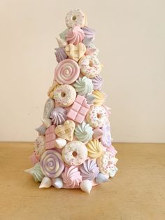 a christmas tree made out of cookies and doughnuts on top of a wooden table