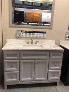 a bathroom vanity with two sinks and a large mirror