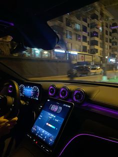 the interior of a car with purple lights