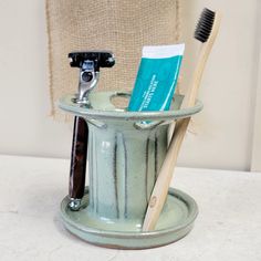 a toothbrush holder with two tooth brushes in it