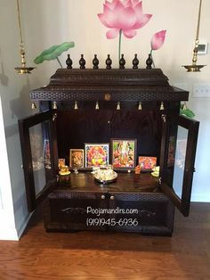 a wooden cabinet with pictures and paintings on it