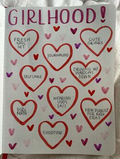 a notebook with hearts drawn on it and the words girlhood written in different languages