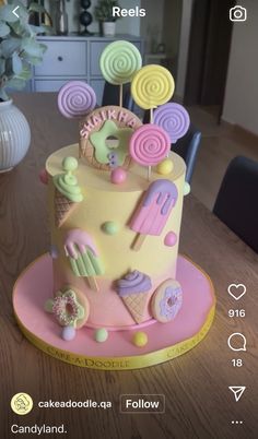 a cake decorated with candy and lollipops on a table