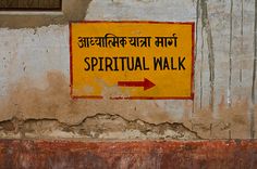 a sign on the side of a building that says, spiritual walk and an arrow pointing to it