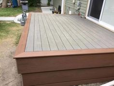 a wooden deck in front of a house