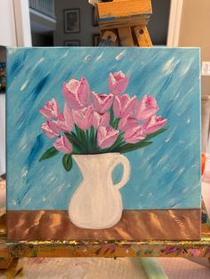 a painting of pink flowers in a white vase