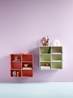 an empty shelf next to a pink wall