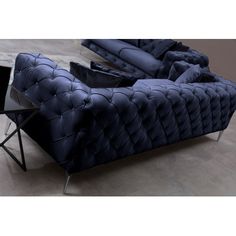 a blue couch sitting on top of a hard wood floor