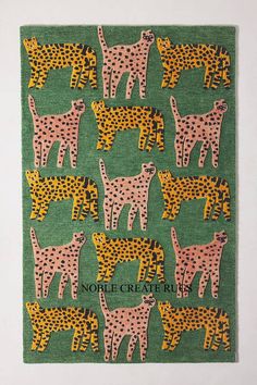 a green rug with pink and yellow cheetah on the front, black and white cheetah on the back