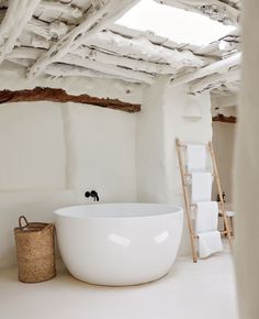 a large white bath tub sitting under a roof