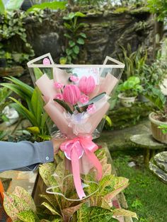 a bouquet of pink flowers in a clear vase