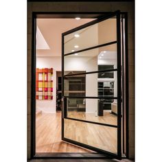 an open glass door leading into a kitchen