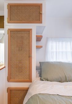 a bedroom with a bed and some shelves on the wall