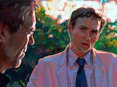 two men are talking to each other in front of some trees and bushes, one is wearing a white shirt and the other has a blue tie