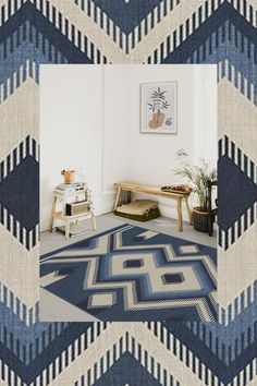 a living room with a blue and white rug on the floor