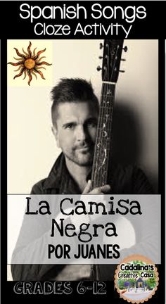 a man holding a guitar in front of a spanish poster with the caption la camisisa negra por juanes