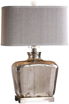 a silver table lamp with a grey shade on it and a white linen lampshade